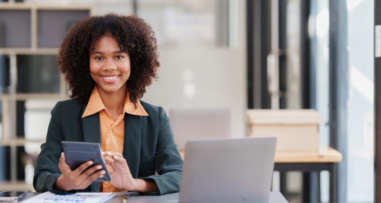 female accounting personnel working with a calculator and a computer