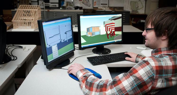 male student drafter at computer