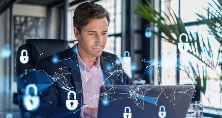 man sitting at computer that has been secured by cyber defense