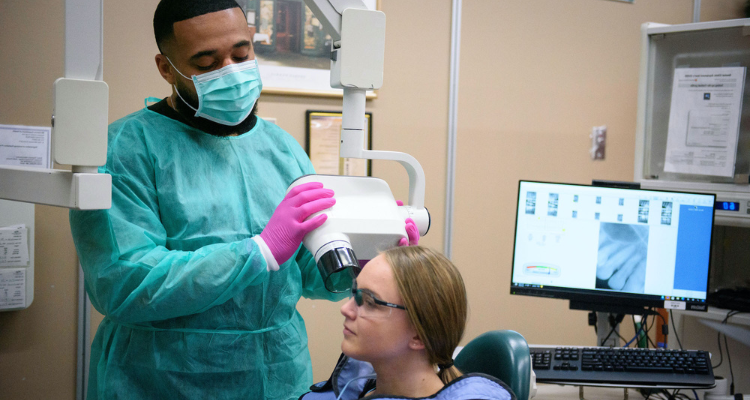 male and female dental assistant students taking oral x-rays