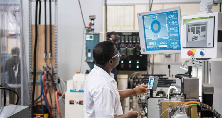 male student operating machine in lab
