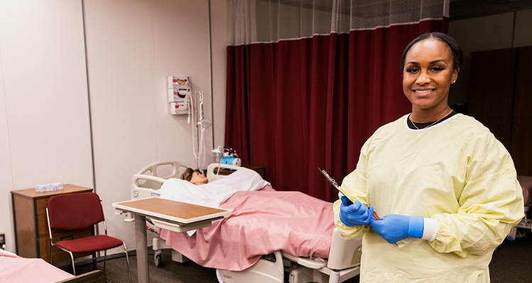 nursing assistant student with dummy practicing skills