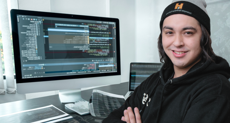 male working at a computer programming software