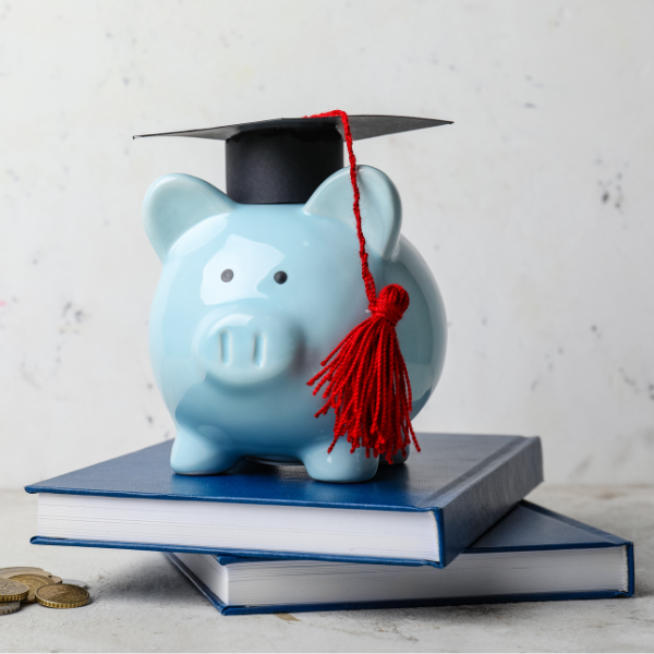 piggy bank with textbooks and hat