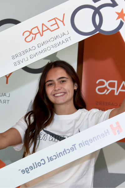 student posing in 50th anniversary cutout