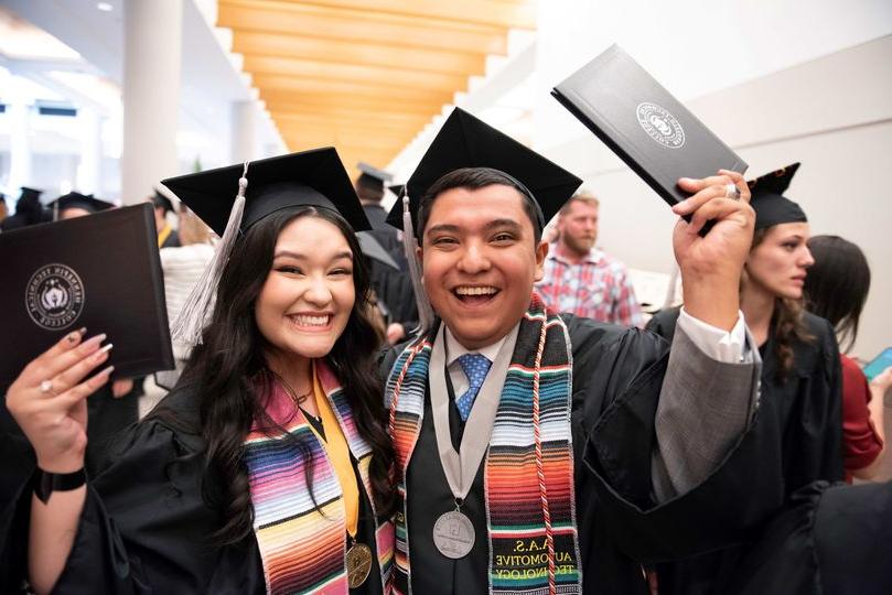 Graduates Josh Rios and his sister celebrate