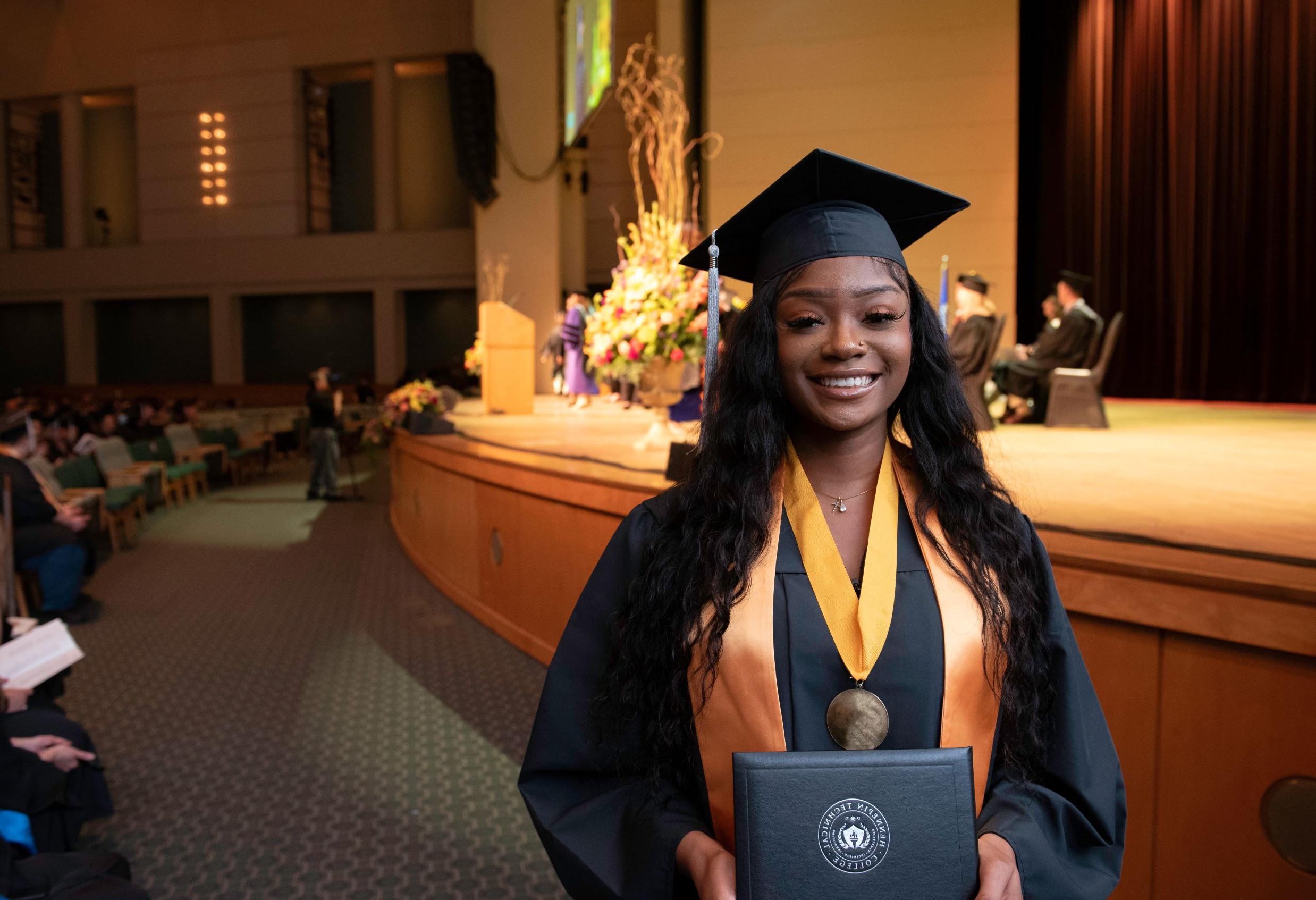 Nursing graduate holds diploma
