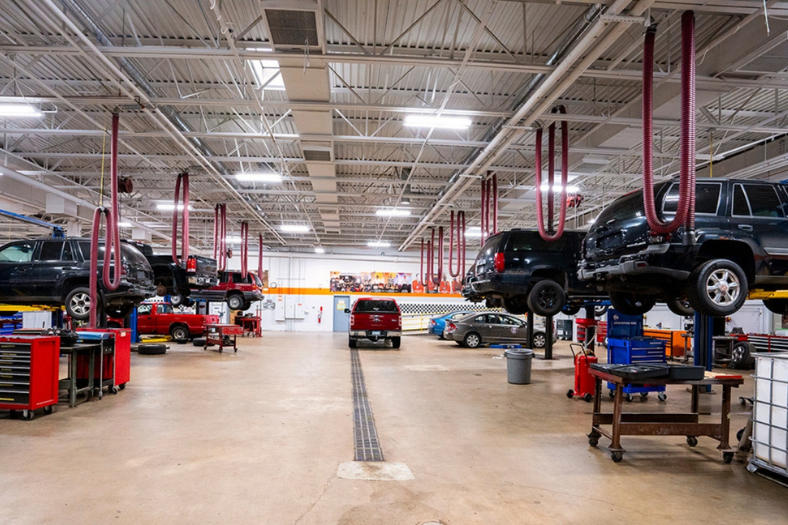 Vehicles on lifts in auto shop classroom lab