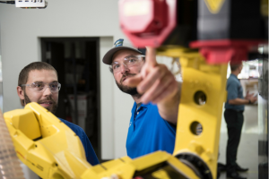 Instructor and student with robotic arm
