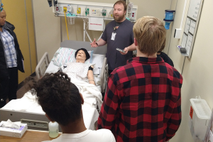 male nursing instructor with high school students